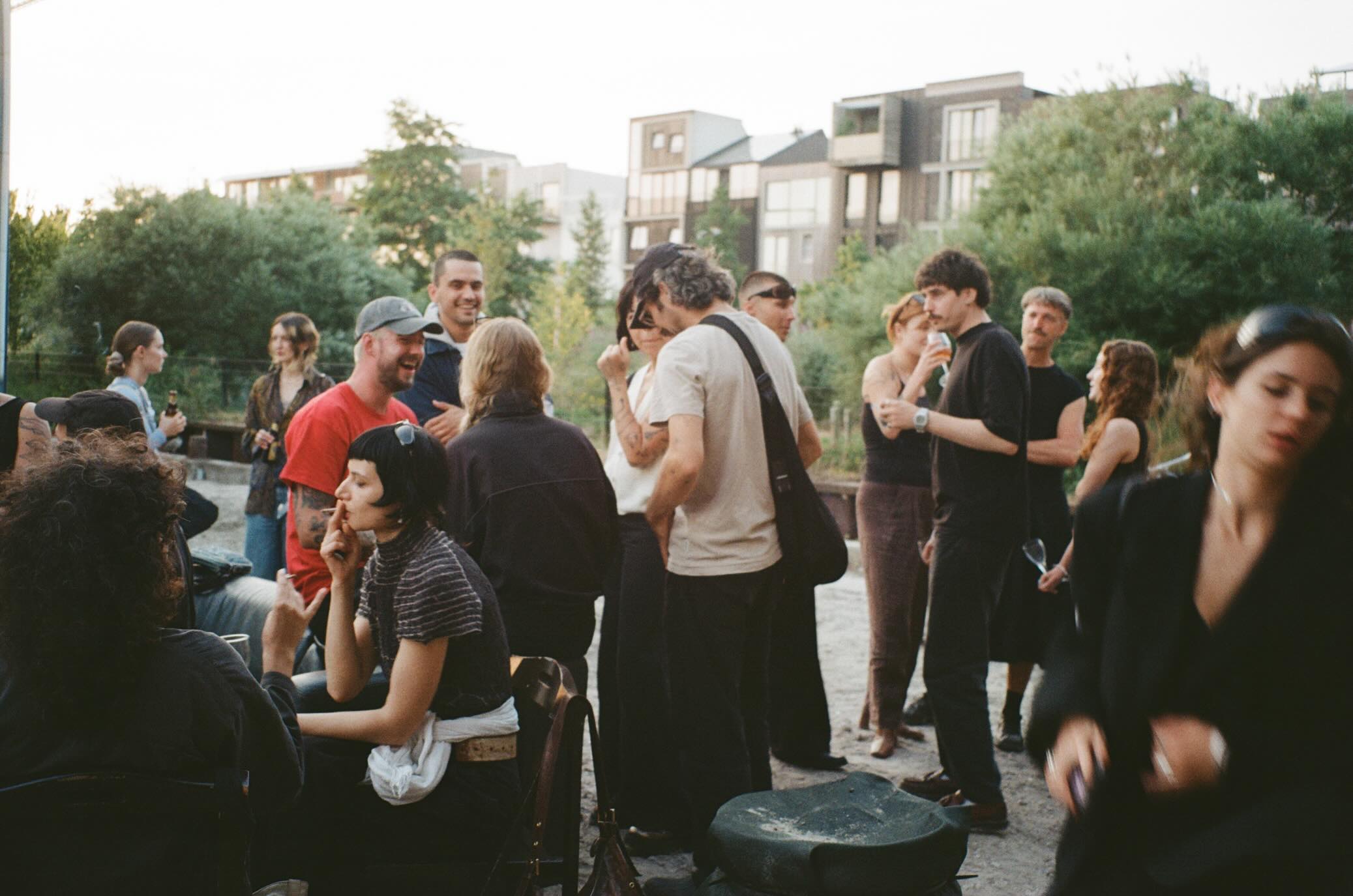 People talking outside Filth in Amsterdam Noord on a summer evening